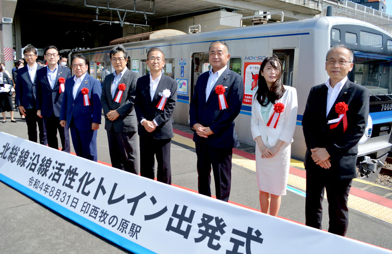 北総線沿線6市の市長らが出席し、自治体広告付き車両の前で行われた出発式=31日、印西市の印西牧の原駅