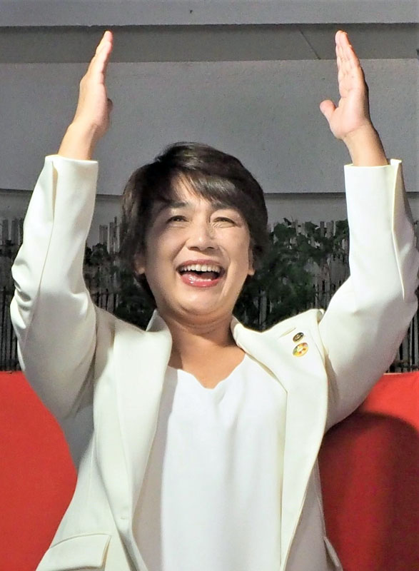 再選を果たし、笑顔で万歳三唱をする石井氏＝２３日夜、君津市