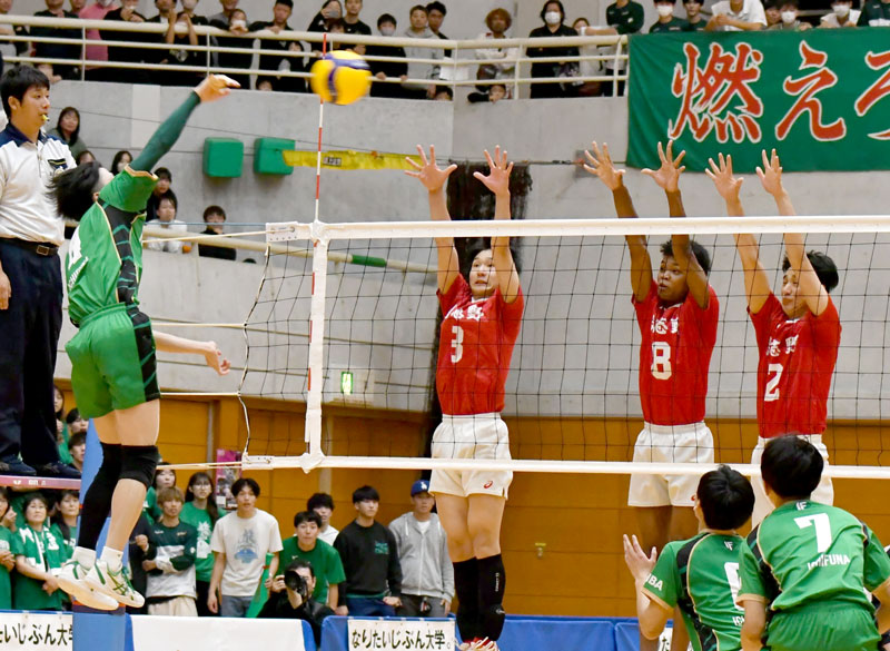 習志野─市船橋 第4セット、ブロックに跳ぶ習志野の菅原(3)ら=東金アリーナ