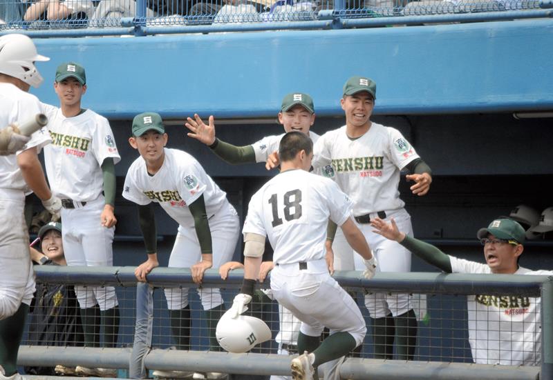 専大松戸―習志野　６回に２点本塁打を放った長谷川（１８）を笑顔で出迎える専大松戸ベンチ＝４日、県総合スポーツセンター野球場